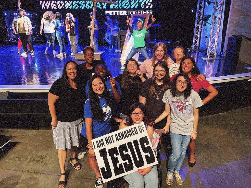Group posing with "I Am Not Ashamed" sign.