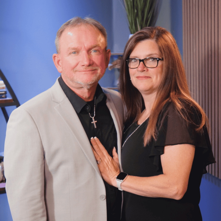 Smiling couple posing in formal attire